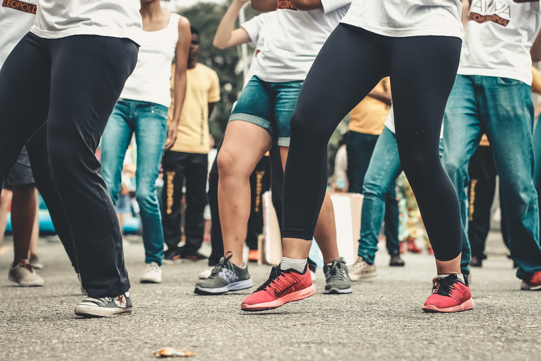 people dancing on concrete pavement