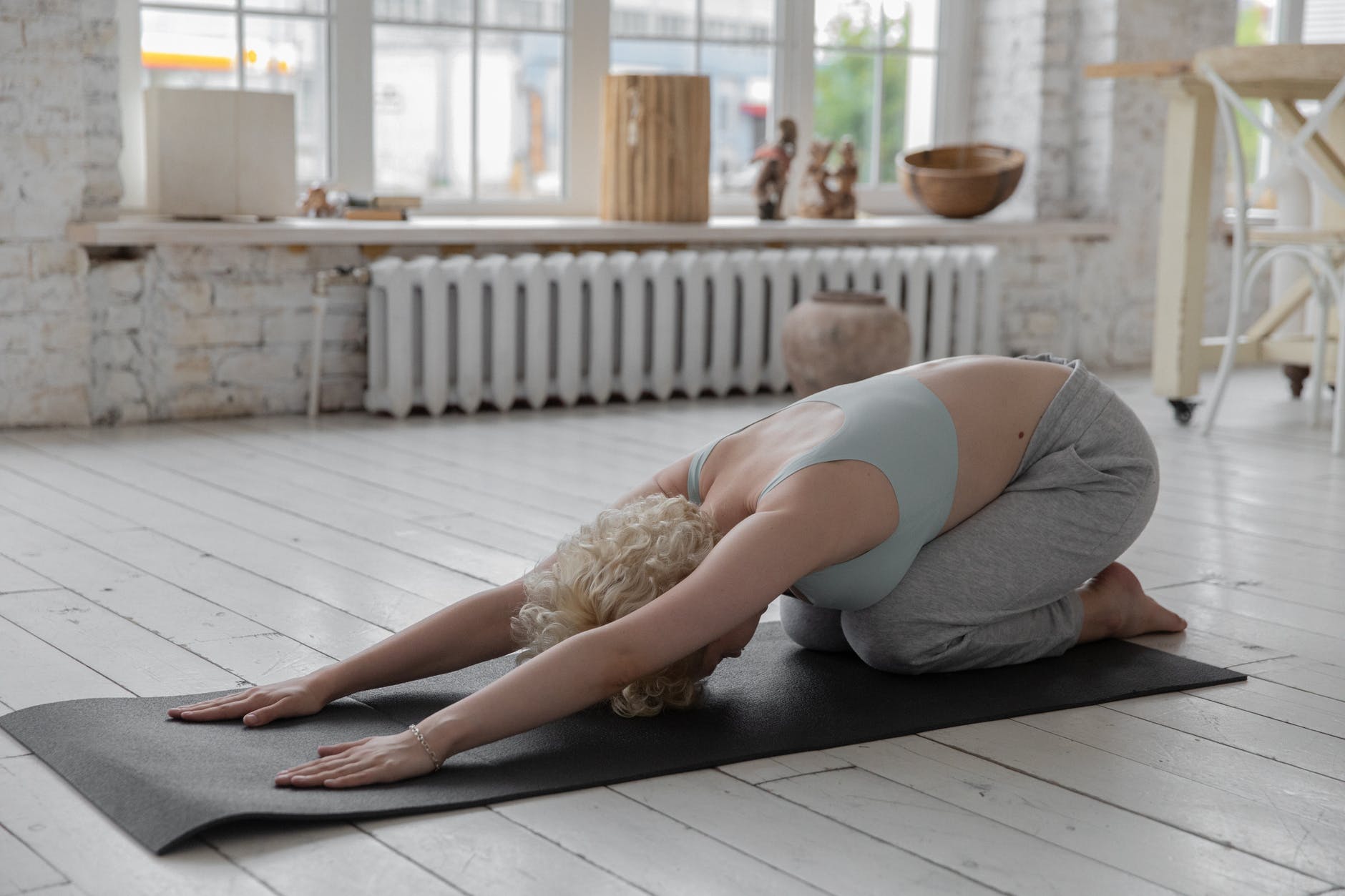 anonymous woman stretching body in extended child s yoga pose